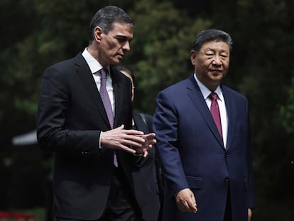 Chinese President Xi Jinping, right and Spanish Prime Minister Pedro Sanchez speak as they walk after a meeting in Beijing on Friday.