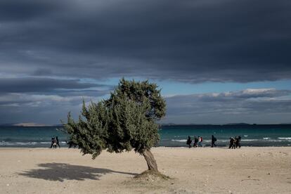 CESME, TURKEY - DECEMBER 03:  Migrants and refugees walk along a beach to wait at a launching point in the coastal town of Cesme on December 3, 2015 in Cesme, Turkey. The flow of boats from Turkey has slowed after a 3bn euro deal was struck between the EU and Turkey, to slow the flow of migrants and refugees to Europe. Since the deal was on November 29th, Turkish police have rounded up approximately 1300 migrants and arrested a number of smugglers. Police checkpoints on the roads leading to launch points have been increased slowing the amount of boats leaving turkish shores.  (Photo by Chris McGrath/Getty Images)