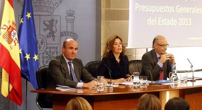 Guindos (izquierda) presenta el programa de reformas en septiembre junto a Soraya Sáenz de Santamaría y Cristóbal Montoro.