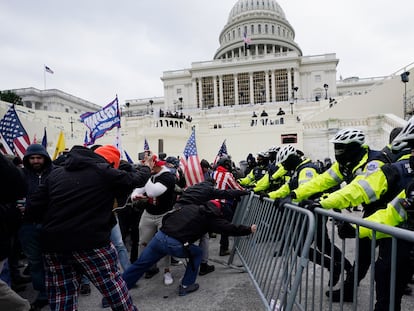 Violent insurrections loyal to President Donald Trump try to break through a police barrier at the Capitol in Washington on Jan. 6, 2021.