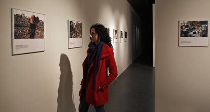 Una mujer recorre la exposición 40 Años de Acción Humanitaria Internacional en el Centre Cultural La Nau de Valencia.