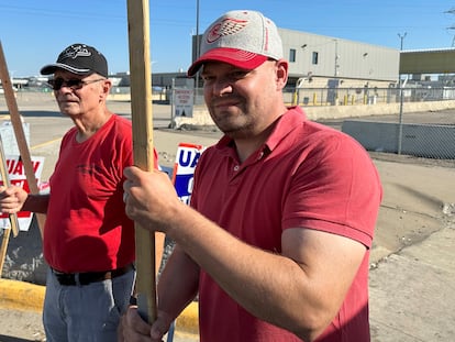 Striking United Auto Workers member Chris Jedrzejek, right, and his father picket outside Ford Motor Co.'s Michigan Assembly Plant Monday, Oct. 2, 2023, in Wayne, Mich.