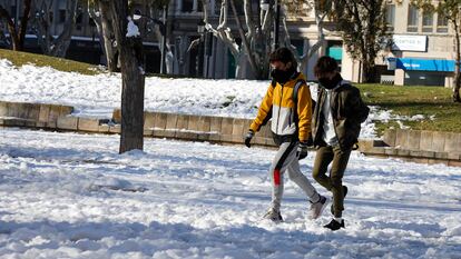 Transeúntes caminan por una vía con nieve durante la ola de frío en Albacete, el pasado 13 de enero,