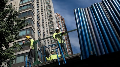 Contractors move sections of scaffolding outside an apartment building in New York, US, on Wednesday, Oct. 11, 2023