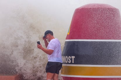  visitor braves the high surf, storm surge and high winds of Hurricane Helene to take photos at the 'Southernmost Point' buoy in Key West, Florida.