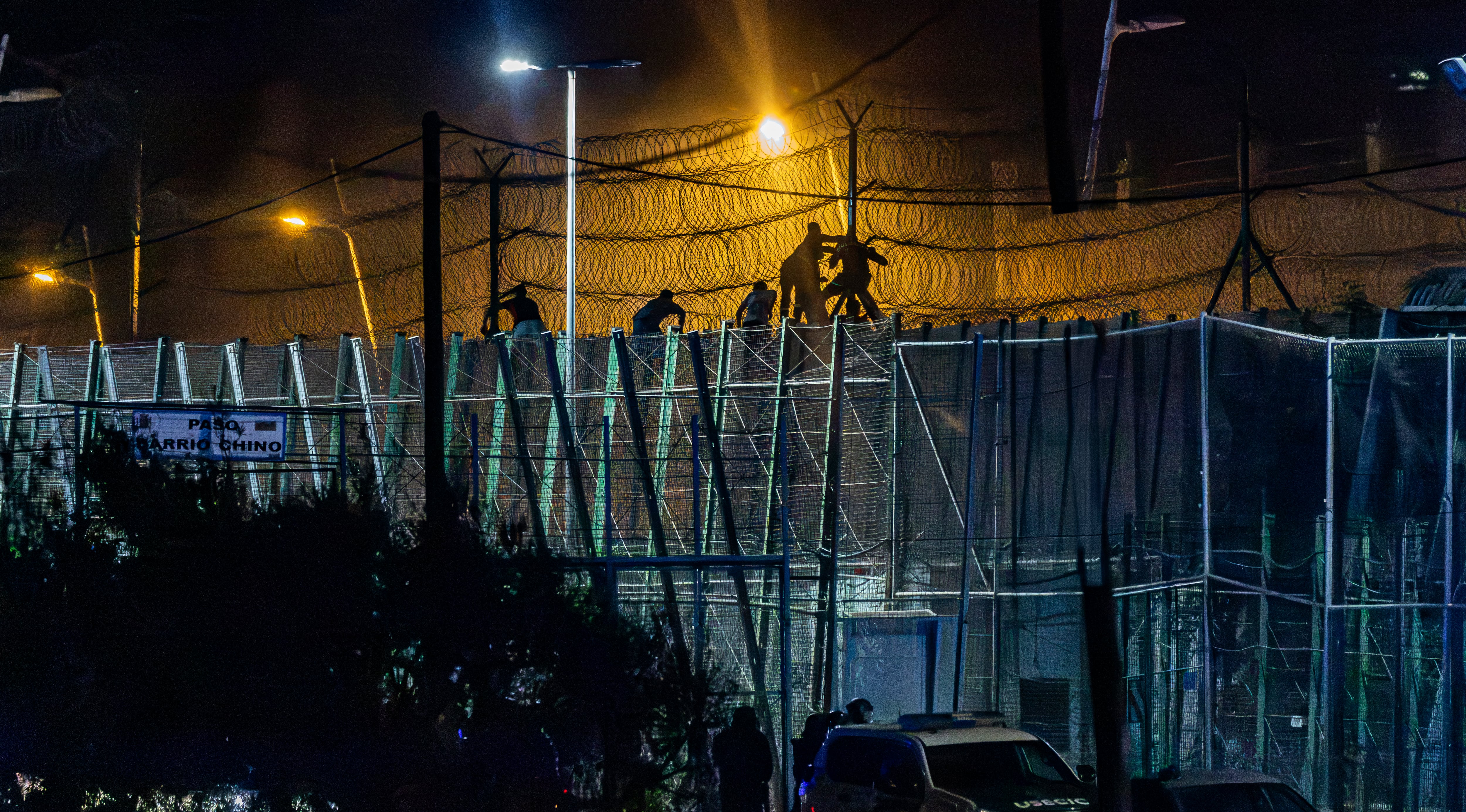 Salto a la valla fronteriza de Melilla de migrantes marroquíes por el antiguo puesto cerrado de Barrio Chino, el 30 de julio.