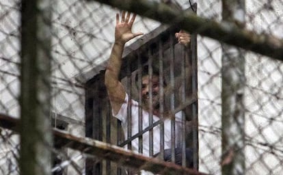 Leopoldo L&oacute;pez greets a crowd from a window at the military prison Ramo Verde in Caracas.
 