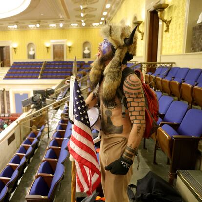 WASHINGTON, DC - JANUARY 06: A protester yells inside the Senate Chamber on January 06, 2021 in Washington, DC. Congress held a joint session today to ratify President-elect Joe Biden's 306-232 Electoral College win over President Donald Trump. Pro-Trump protesters entered the U.S. Capitol building during mass demonstrations in the nation's capital. (Photo by Win McNamee/Getty Images)