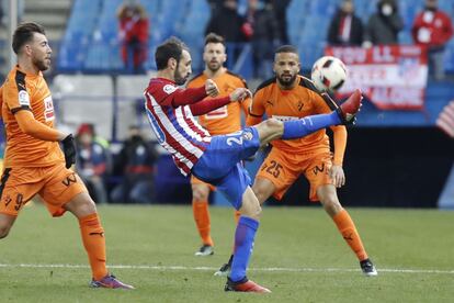 El defensa del Atlético de Madrid Juanfran Torres (c) ante el delantero Sergi Enrich y el delantero portugués Tiago Dias, "Bebé" (d), del Eibar.