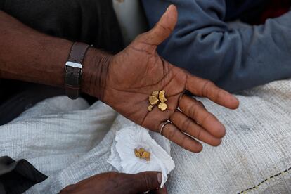 A miner displays several gold nuggets in Alto Alegre.