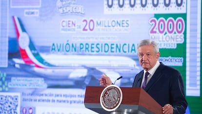 In this photo provided by Mexico's Presidential Press Office, President Andres Manuel Lopez Obrador stands in front of an image of a raffle ticket featuring the presidential plane, in his morning press conference at the National Palace in Mexico City, Friday, Feb. 7, 2020. Lopez Obrador announced that the raffle of the Boeing Dreamliner will be symbolic, awarding total prize money of $100 million, which lottery tickets state is "equivalent to the value of the presidential jet." (Mexico's Presidential Press Office via AP)