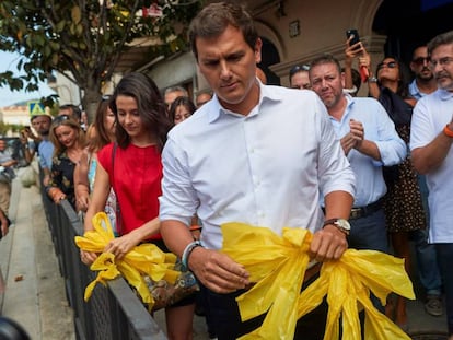 Albert Rivera e Inés Arrimadas, retiran lazos amarillos durante el recorrido que hicieron junto a cargos y afiliados del partido por la localidad barcelonesa de Alella.