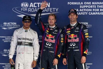 Vettel celebra la 'pole' junto a Hamilton y Webber