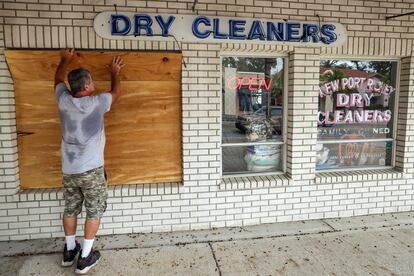 Jay McCoy puts up plywood in preparation for Hurricane Milton on Monday, Oct. 7, 2024, in New Port Richey, Fla.