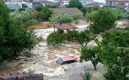 Floodwaters cover a car and the yards of houses in Milina village, Pilion region, central Greece, Tuesday, Sept. 5, 2023