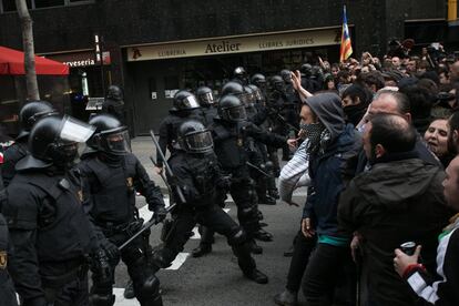 Police hold back protesters in Barcelona.