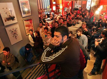 Un grupo de personas asiste a la proyección del vídeo <i>Ja en tenim prou</i> en un local de Valencia.