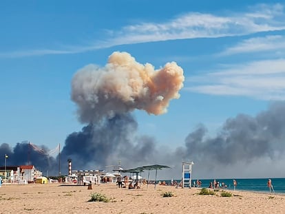 FILE - Rising smoke can be seen from the beach at Saky after explosions were heard from the direction of a Russian military airbase near Novofedorivka, Crimea, Aug. 9, 2022. (UGC via AP, File)