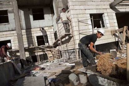 Obreros palestinos trabajan en la construcción de un bloque de viviendas en Har Homa, en Jerusalén Este.