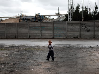A boy walks through an impoverished neighborhood on the outskirts of Buenos Aires, Argentina, in October 2019.