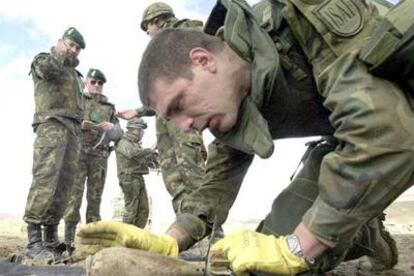 Un sargento español inspecciona una granada sin explotar en la carretera de Jalalabad a Kabul.