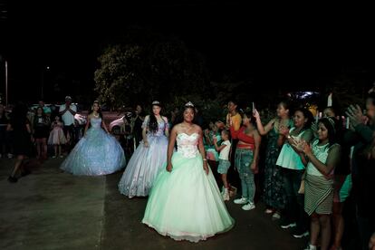 Las quinceañeras hacen su aparición, con vestidos, maquillaje y tiaras, ante sus familiares.