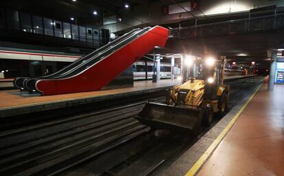 Una excavadora circula por las vías de la estación de Atocha.