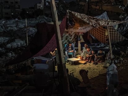 GAZA CITY, GAZA - MAY 24: Palestinians sit in a tent that has been set up on top of the ruins of a building destroyed in recent Israeli air strikes, in Gaza City on May 24, 2021 in Gaza City, Gaza. Gaza residents continue clean up operations as they return to damaged and destroyed homes as the ceasefire between Israel and Hamas appeared to be holding into a fourth day. The ceasefire brings to an end eleven days of fighting which killed more than 250 Palestinians, many of them women and children, and 13 Israelis. The conflict began on May 10th after rising tensions in East Jerusalem and clashes at the Al Aqsa Mosque compound. (Photo by Fatima Shbair/Getty Images)