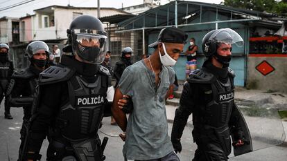 Dos policías llevan detenido a un hombre durante las protestas contra el Gobierno cubano en La Habana, este lunes.