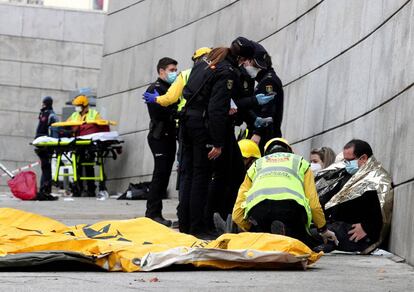 The emergency services aiding people injured in today's blast in Madrid.
