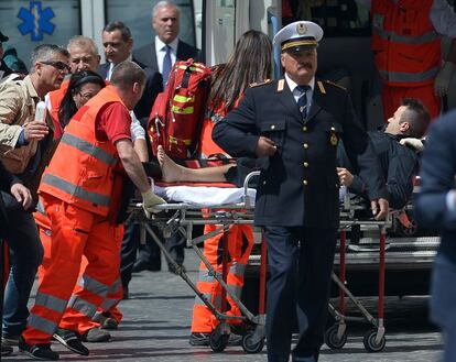 Los servicios sanitarios trasladan a uno de los carabinieri heridos en el tiroteo en la puerta de la sede de la Presidencia del Gobierno.