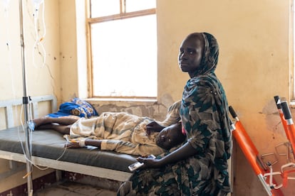 A woman cares for her son, who has been admitted to the hospital in Renk, northern South Sudan.