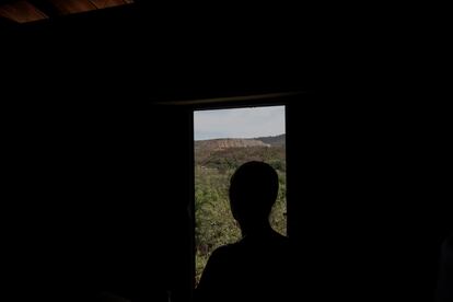 From the window of her house, Maria de Fátima observes the operation of the Sigma Lithium company's lithium extraction trucks.