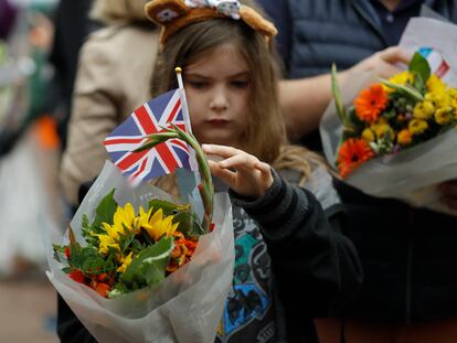 A young girl holds flowers outside Buckingham Palace in London, Britain, 10 September 2022.