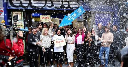 People celebrate at Madrid’s famous Doña Manolita lottery shop, which sold the top prize.