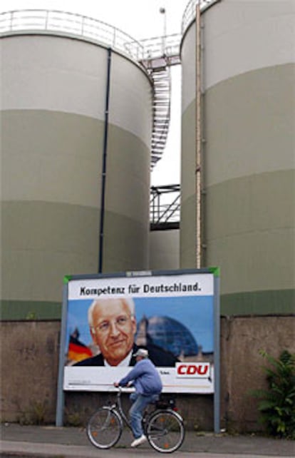 Un ciclista, ante un cartel de Stoiber en un complejo industrial en el Este.