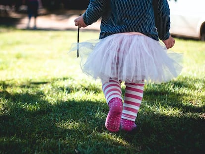 Una niña camina por su jardín. 