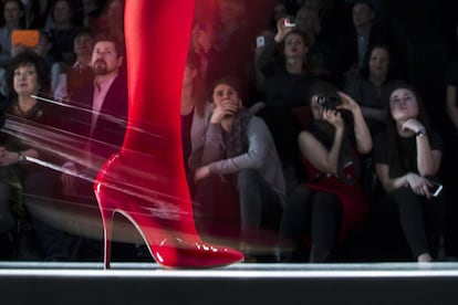 Espectadores observam modelo que mostra a criação do designer russo Slava Zaitsev durante a Semana da Moda em Moscou, na Rússia.