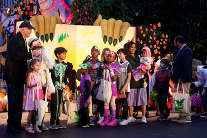 President Joe Biden poses for a photo with trick-or-treaters on the South Lawn of the White House, on Halloween