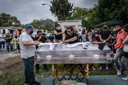 Familiares colocan en el féretro las playeras de fútbol que usaba Daniel Picazo. 