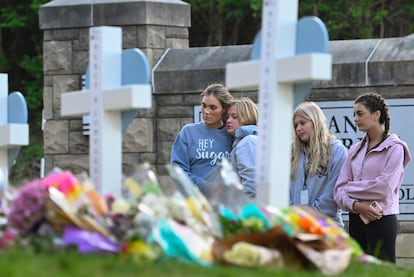 Students at a nearby school pay respects at a memorial for the people who were killed, at an entry to Covenant School, Tuesday, March 28, 2023, in Nashville, Tennessee