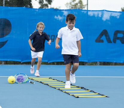 "Lo bueno de los deportes de implemento de raqueta es que permiten el trasvase de unos a otros sin apenas esfuerzo; puedes comenzar en bádminton y acabar en tenis o al revés", explica Gema García. Si se opta por el tenis y el niño es muy pequeño, se comienza con actividades pretenis, es decir, se aprenden los movimientos y capacidades básicas del futuro deporte con elementos como balones de playa, muy ligeros y suficientemente grandes como para alcanzarlos. Entre los seis y ocho años el minitenis es lo idóneo, con adaptación de campo (más corto), raqueta (más pequeña y ligera) y pelota (de menor presión). Los niños desarrollarán la motricidad, tonificarán la musculatura, tendrán más resistencia aeróbica y mejorarán los reflejos y la flexibilidad. Al ser, como el bádminton, unilateral, es recomendable compatibilizarlo con otro deporte más completo. Zapatillas, polo/camiseta, pantalón/falda y raqueta cuestan en conjunto desde 24 euros en <a href="https://www.decathlon.es/C-1330007-tenis?utm_source=themamas&thepapas&utm_medium=display&utm_campaign=Decathlon_Vuelta al Deporte_2018-08-07_2018-10-18_RET_&utm_term=UM&utm_content=" >Decathlon</a>.