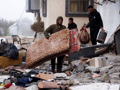 Several people collect belongings from a bombed house in Rafah, in the Gaza Strip, on February 9.