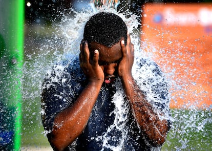 A man cools off in a water fountain in Texas on June 20, 2023.