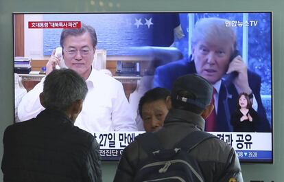 En la televisión, una conversación telefónica entre Donald Trump y el presidente de Corea del Sur, Moon Jae-in, en la estación de trenes de Seúl, la semana pasada