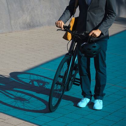 Low section of businessman standing with bicycle on street