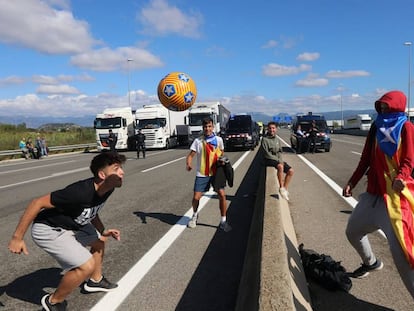 An impromptu soccer game on the C-25 road near Gurb, Catalonia on Tuesday.