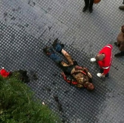 A man lies in the street in M&aacute;laga after setting himself on fire. 