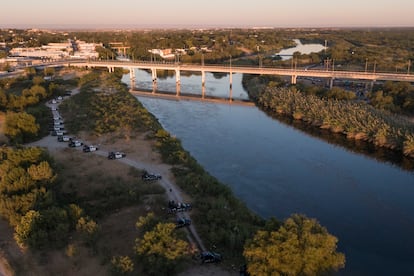 Una hilera de vehículos de la policía municipal de Ciudad Acuña custodia el Río Bravo frente al puente internacional de Del Río, este jueves.