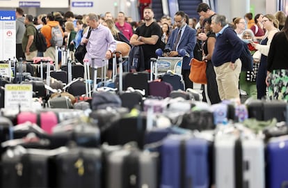Travelers wait for their bags amid rows of unclaimed luggage at the United Airlines baggage claim area at Los Angeles International Airport (LAX) on June 29, 2023 in Los Angeles, California